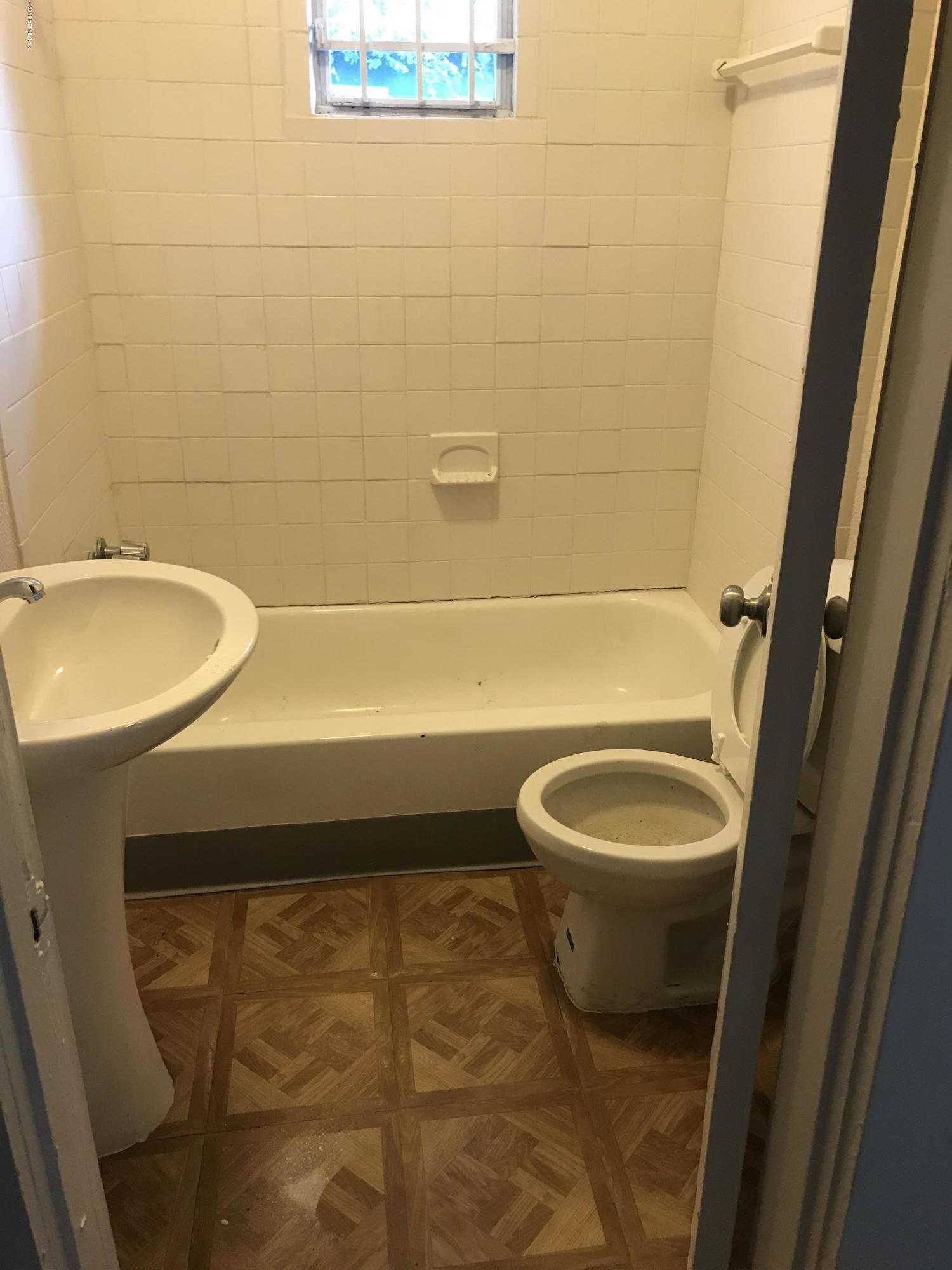 5606 Moncrief Road Jacksonville, FL 32209 - Photo 8 of 26 a bathroom with a sink a toilet and shower