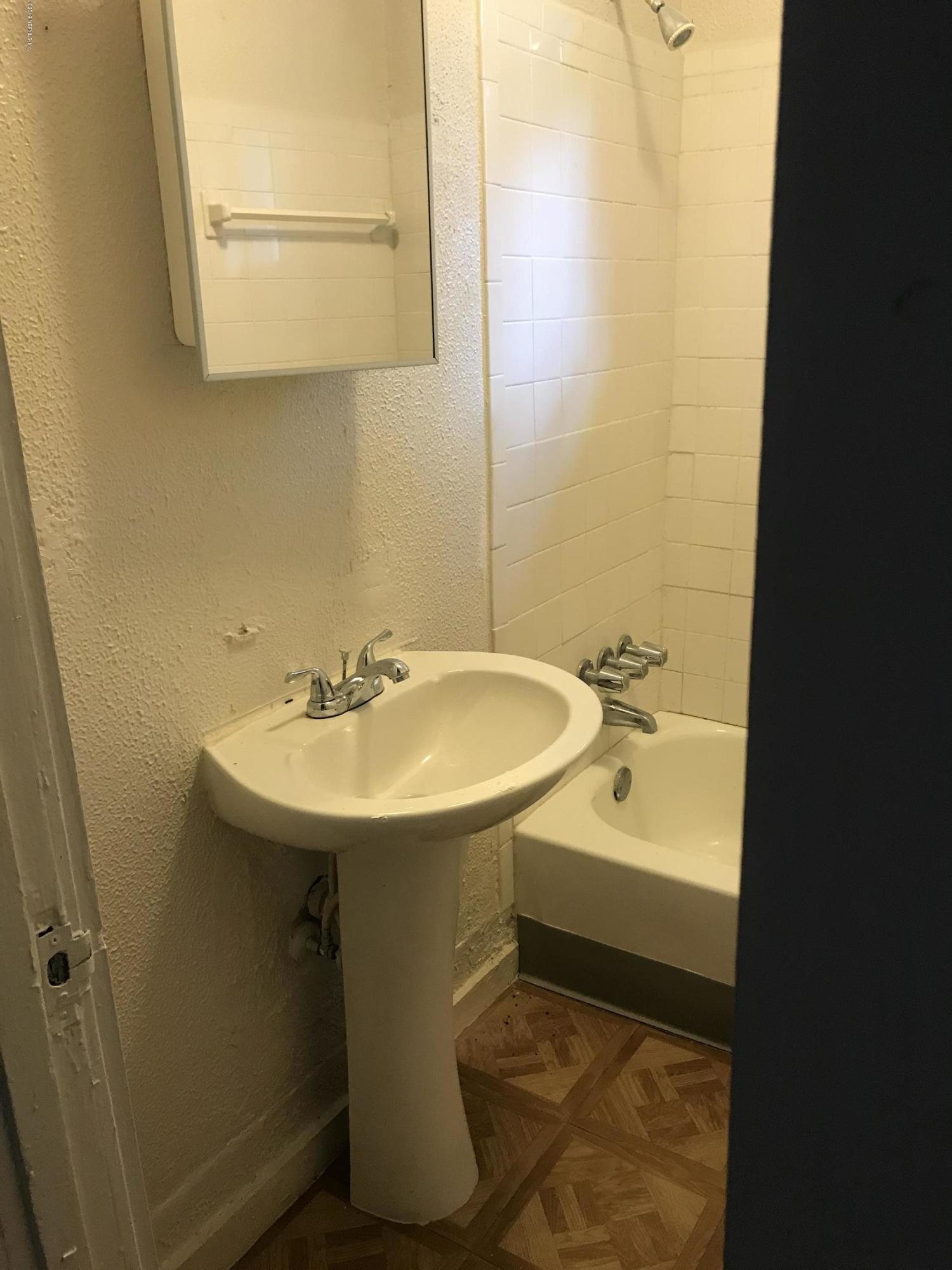 5606 Moncrief Road Jacksonville, FL 32209 - Photo 9 of 26 a bathroom with a sink and a mirror