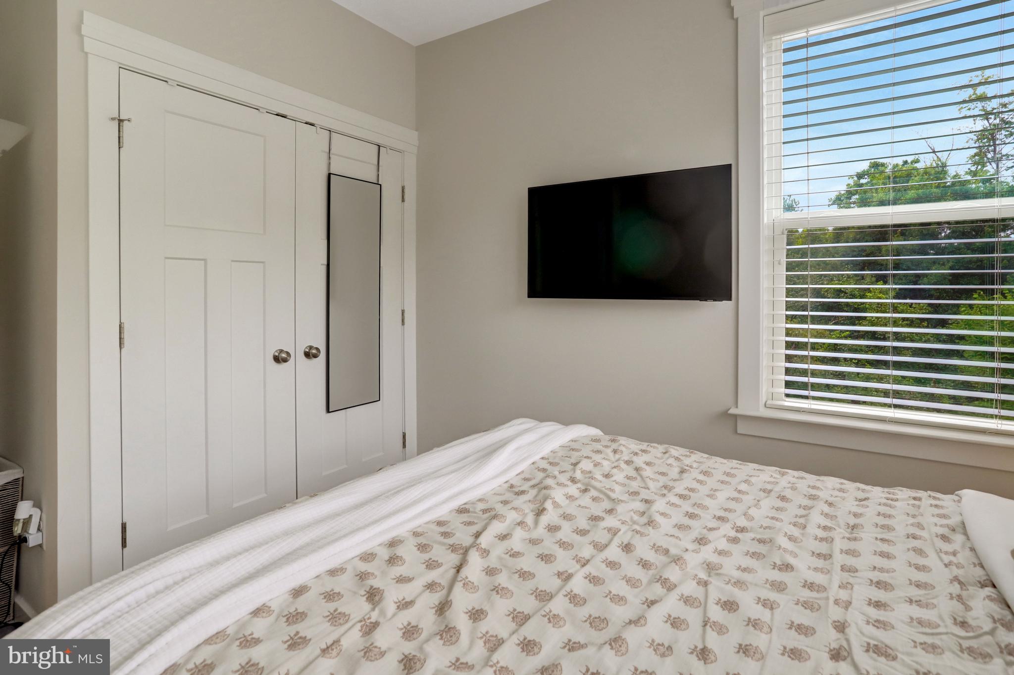 9180 Snowden Ashford Road Lorton, VA 22079 - Photo 17 of 28 a bedroom with a bed and a flat screen tv