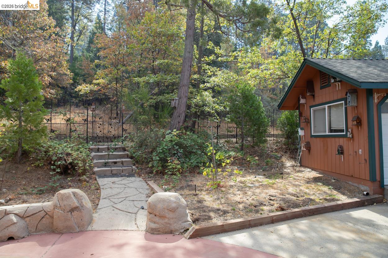 22401 Ridge Road Twain Harte, CA 95383 - Photo 39 of 52 Stone-look retaining wall with flagstone pathway, leading to stepped natural stone entry