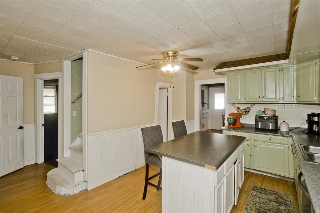 80 Stewart Street Chicopee, MA 01020 - Photo 15 of 37 a kitchen with a sink a refrigerator and cabinets