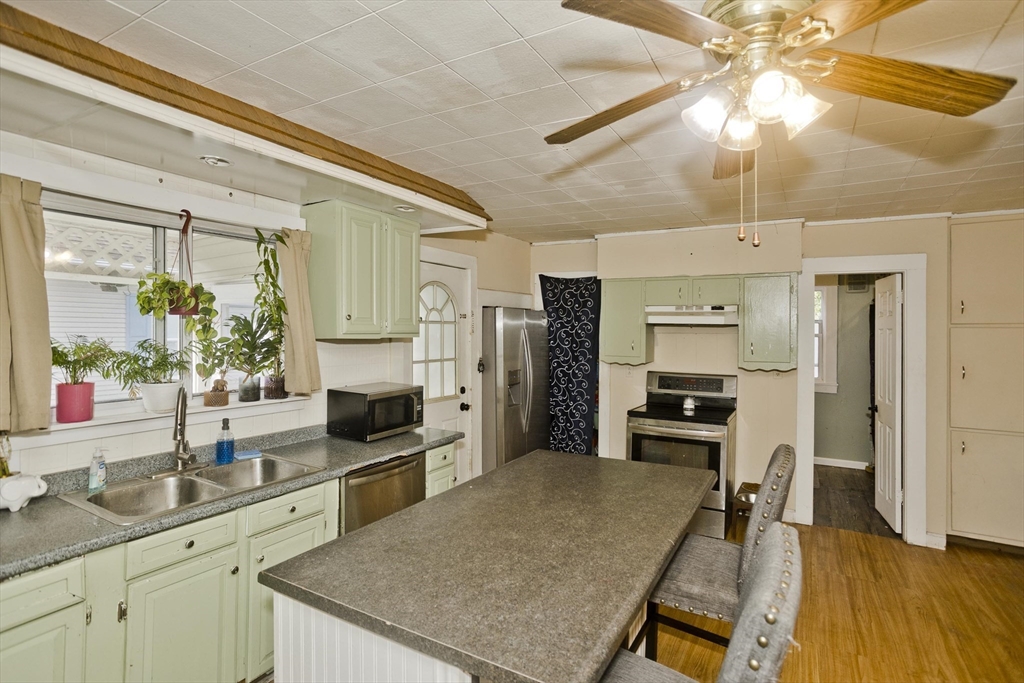 80 Stewart Street Chicopee, MA 01020 - Photo 18 of 37 a kitchen with stainless steel appliances a stove refrigerator sink and cabinets