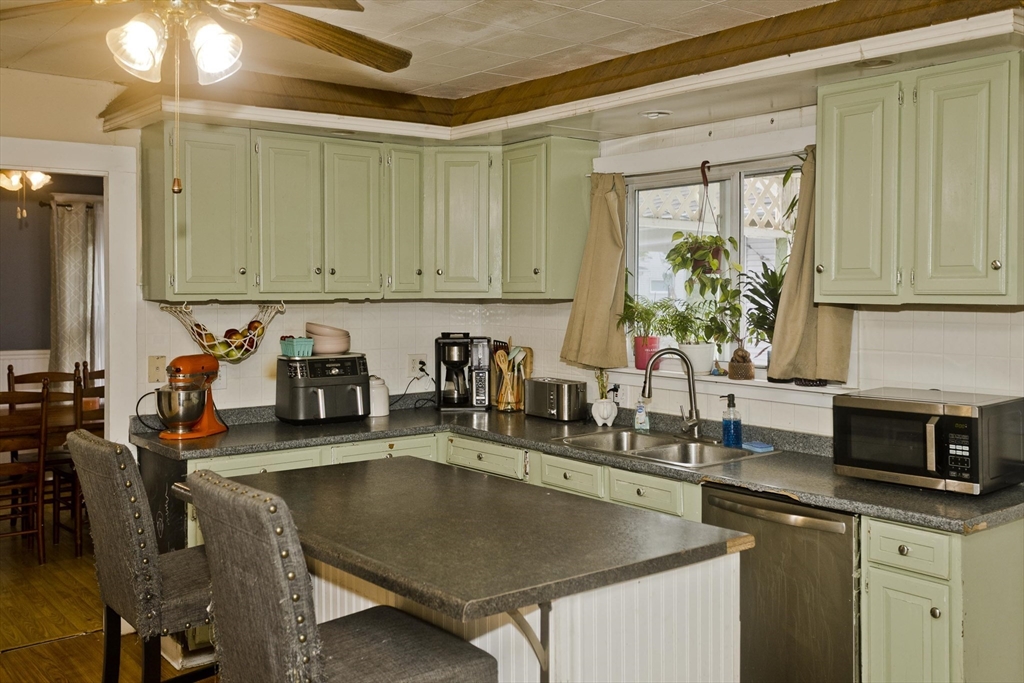 80 Stewart Street Chicopee, MA 01020 - Photo 20 of 37 a kitchen with a table chairs and a stove
