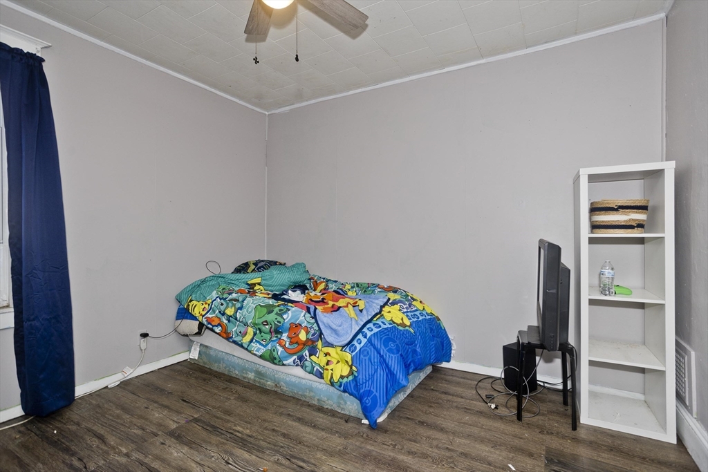 80 Stewart Street Chicopee, MA 01020 - Photo 24 of 37 a bedroom with a bed and a chandelier