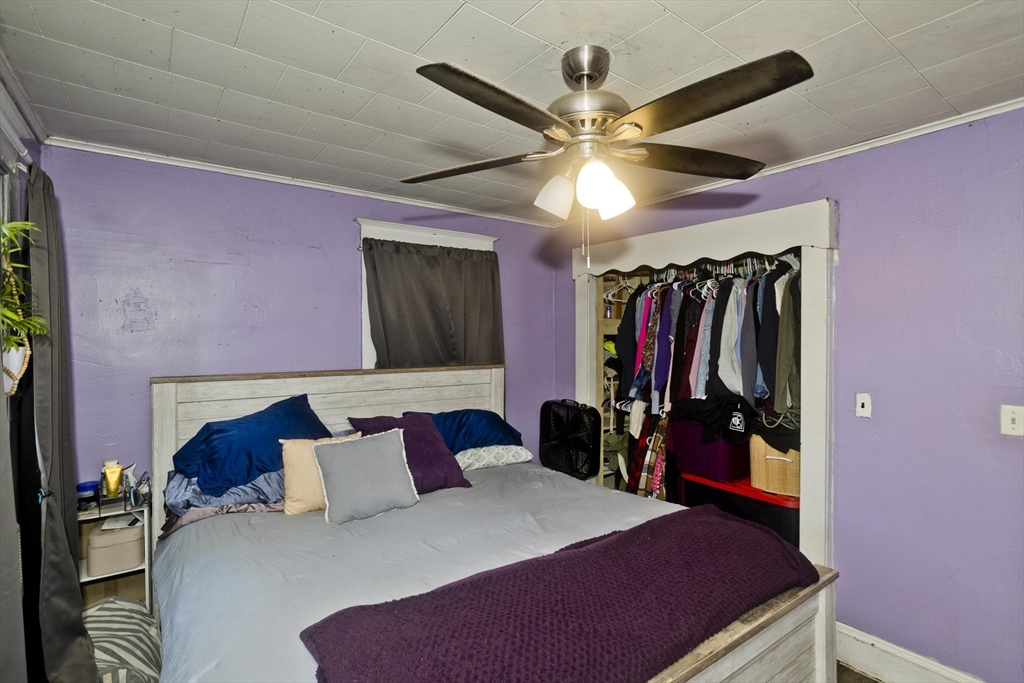 80 Stewart Street Chicopee, MA 01020 - Photo 26 of 37 a bedroom with a bed and a walk in closet