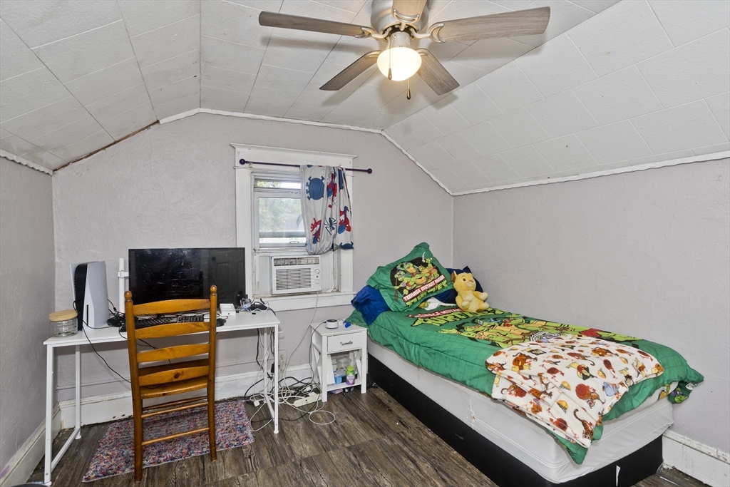 80 Stewart Street Chicopee, MA 01020 - Photo 30 of 37 a bedroom with a bed and a chandelier