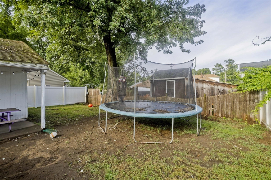 80 Stewart Street Chicopee, MA 01020 - Photo 36 of 37 a view of a backyard with table and chairs