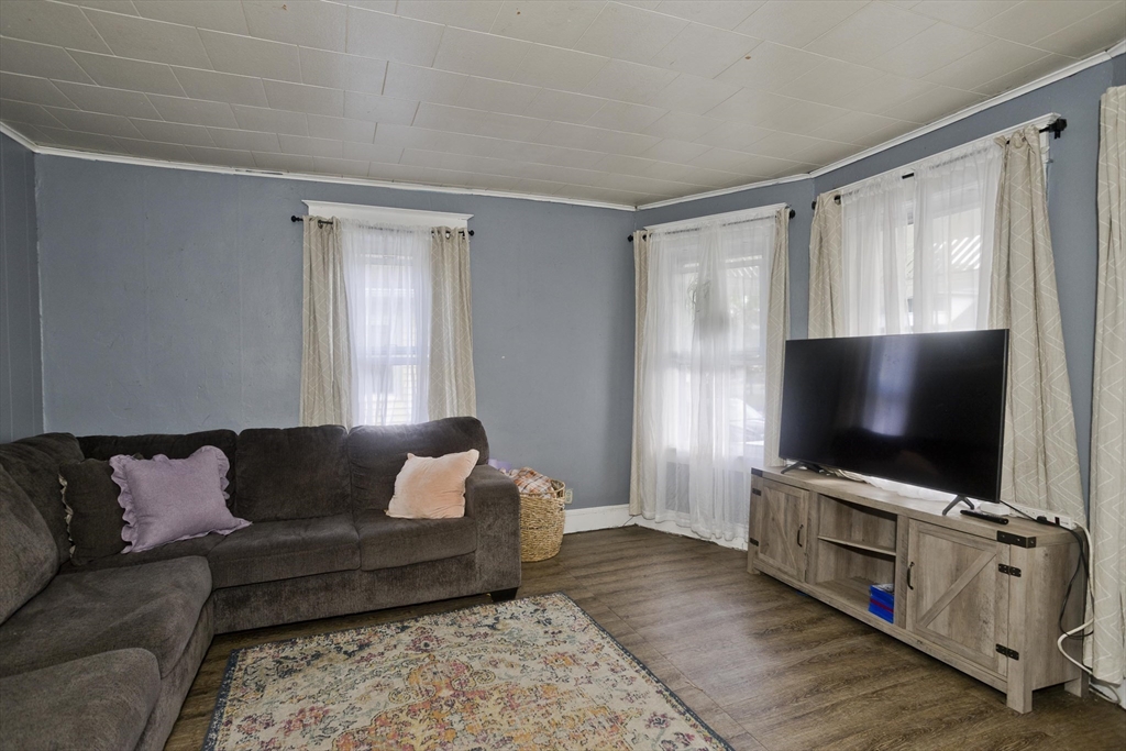 80 Stewart Street Chicopee, MA 01020 - Photo 8 of 37 a living room with furniture and a flat screen tv