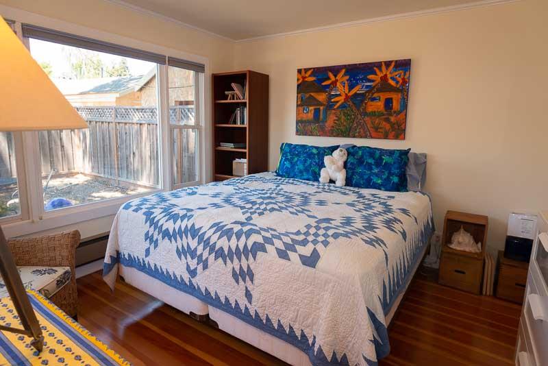 705 Oak Drive Capitola, CA 95010 - Photo 13 of 17 a bedroom with a bed and a book shelf