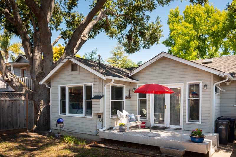 705 Oak Drive Capitola, CA 95010 - Photo 14 of 17 a front view of house with yard outdoor seating and covered with trees