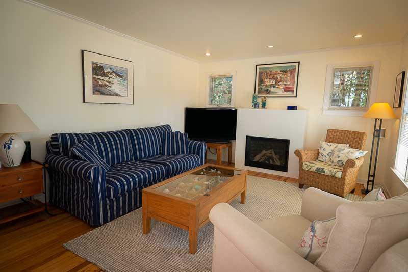 705 Oak Drive Capitola, CA 95010 - Photo 4 of 17 a living room with furniture a flat screen tv and a fireplace