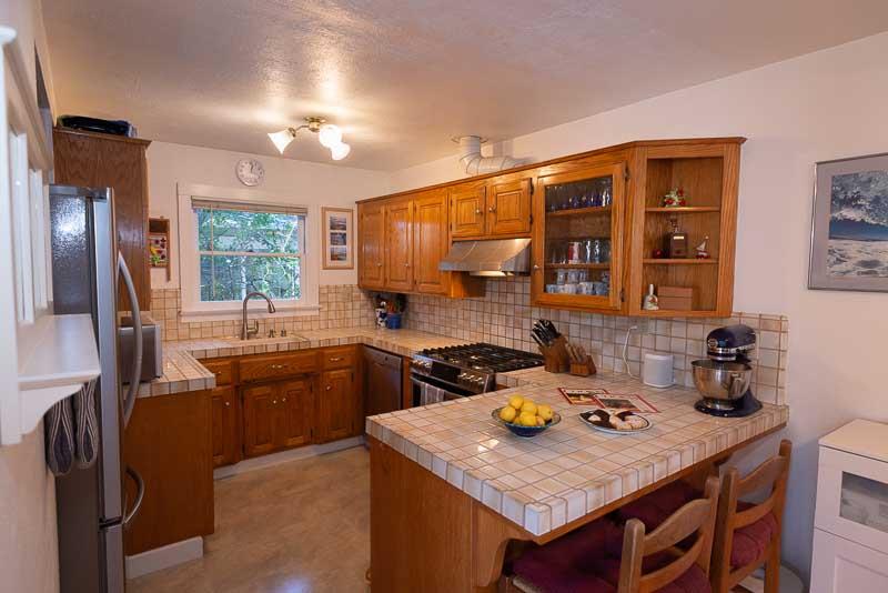 705 Oak Drive Capitola, CA 95010 - Photo 7 of 17 a kitchen with a stove a sink dishwasher and a refrigerator