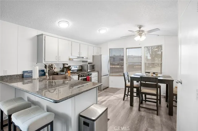a kitchen with a table chairs stove and cabinets