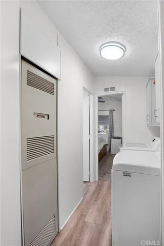 a view of a hallway with washer and dryer