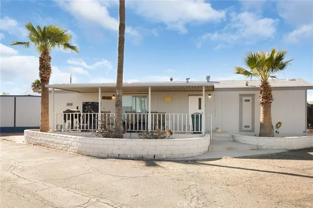 a view of a house with a balcony and potted plants