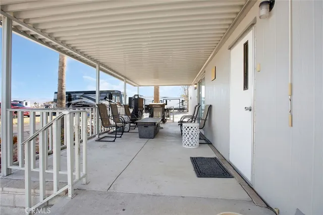 a view of a patio with table and chairs