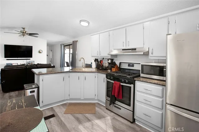a kitchen with a sink stove and refrigerator