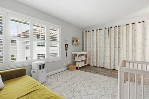 a bedroom with a bed and a large window
