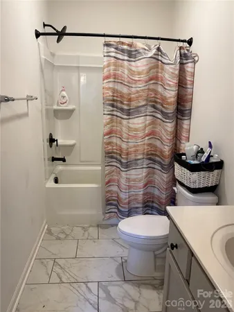 a bathroom with a shower a toilet and a shower