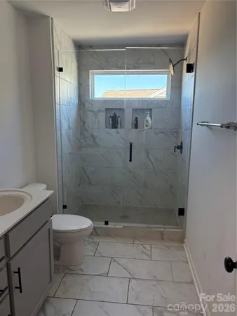 a bathroom with a shower and a toilet