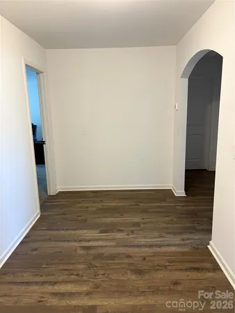 a view of a room with wooden floor and staircase