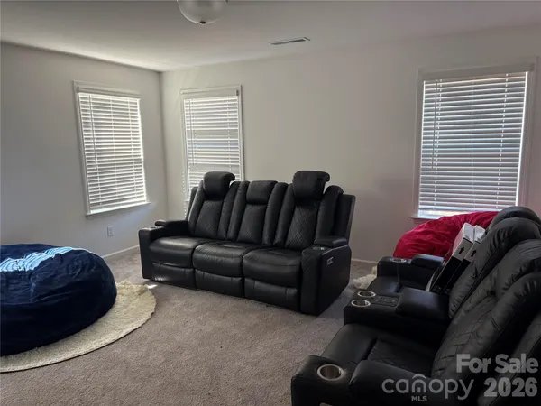 a living room with furniture a window and a couch