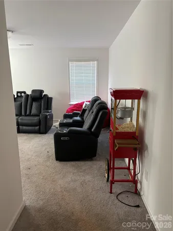 a living room with furniture a lamp and a window