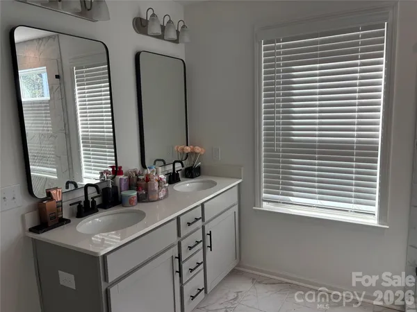 a view of a chairs and table in the back yard of the house