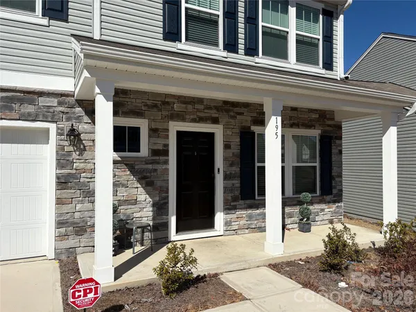 a front view of a building with a potted plant