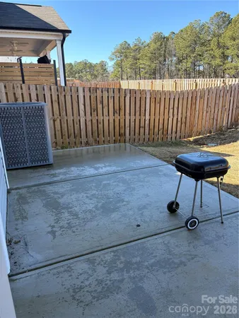 a view of a house with backyard porch and furniture