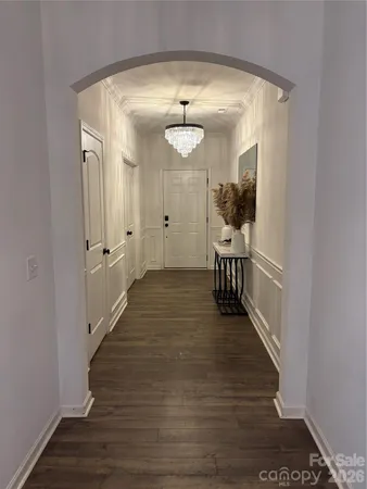 a view of a hallway view with wooden floor and staircase