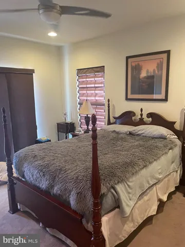 a bedroom with bed and window