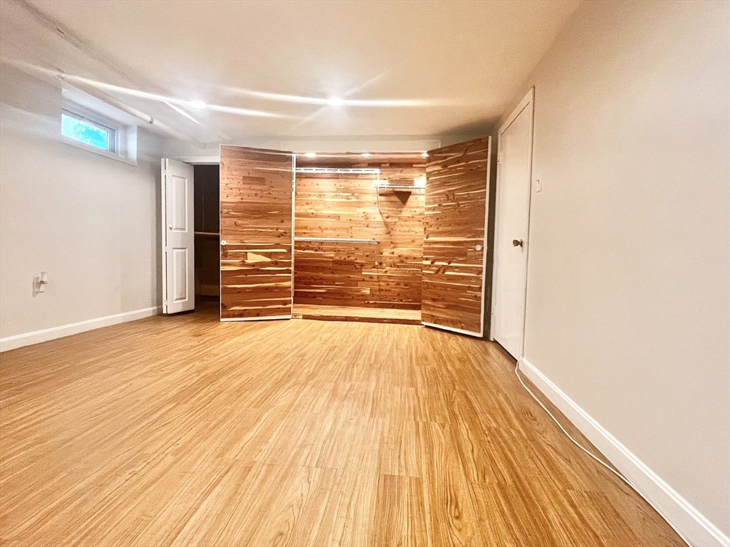 8 A Mellon Road Wellesley, MA 02482 - Photo 13 of 22 a view of empty room with wooden floor