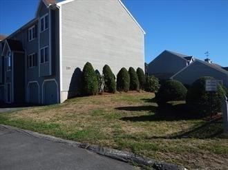 64 Tennis Plaza Road, Unit 2 Dracut, MA 01826 - Photo 2 of 11 a view of a house with a backyard
