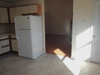 64 Tennis Plaza Road, Unit 2 Dracut, MA 01826 - Photo 6 of 11 a white refrigerator freezer sitting in a kitchen