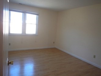 64 Tennis Plaza Road, Unit 2 Dracut, MA 01826 - Photo 9 of 11 an empty room with a window