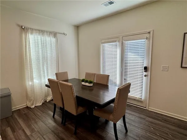 a view of a dining room with furniture window and wooden floor