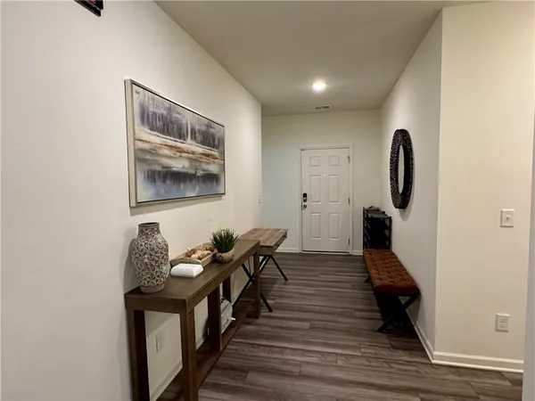 a hallway with wooden floor and furniture