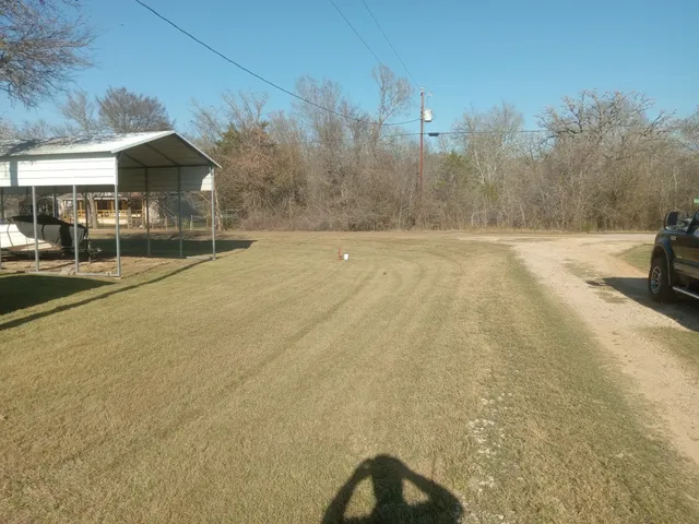 a swimming pool with outdoor seating and yard