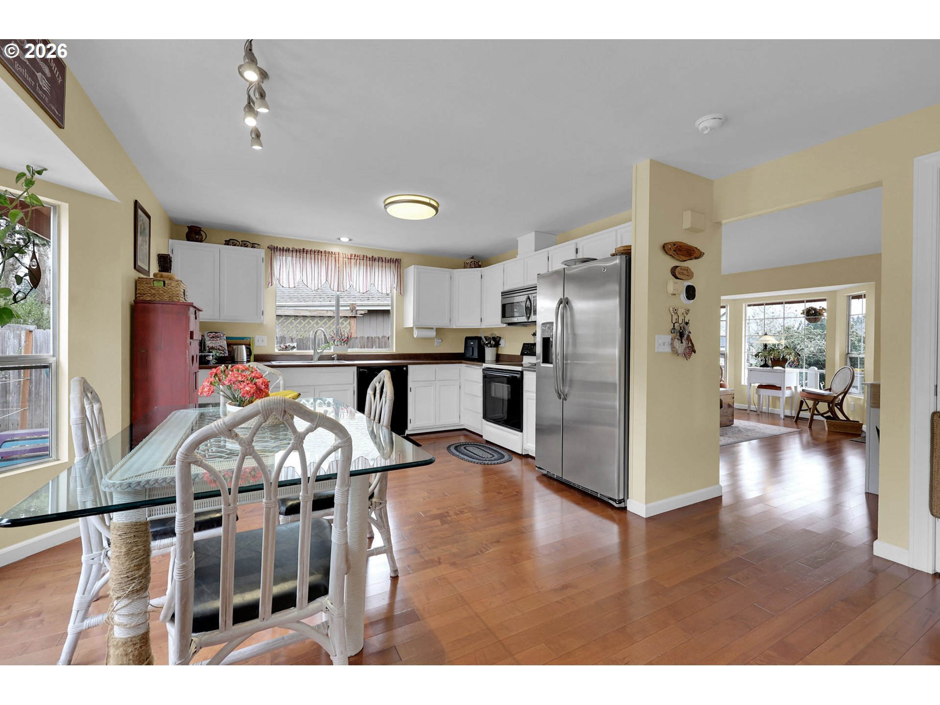 4452 Jessica Drive Springfield, OR 97478 - Photo 12 of 43 a kitchen with stainless steel appliances granite countertop a refrigerator oven stove a sink dishwasher and white cabinets with wooden floor