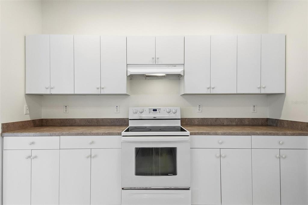 29 East Diamond Drive Palm Coast, FL 32164 - Photo 11 of 55 a kitchen with granite countertop white cabinets and white appliances