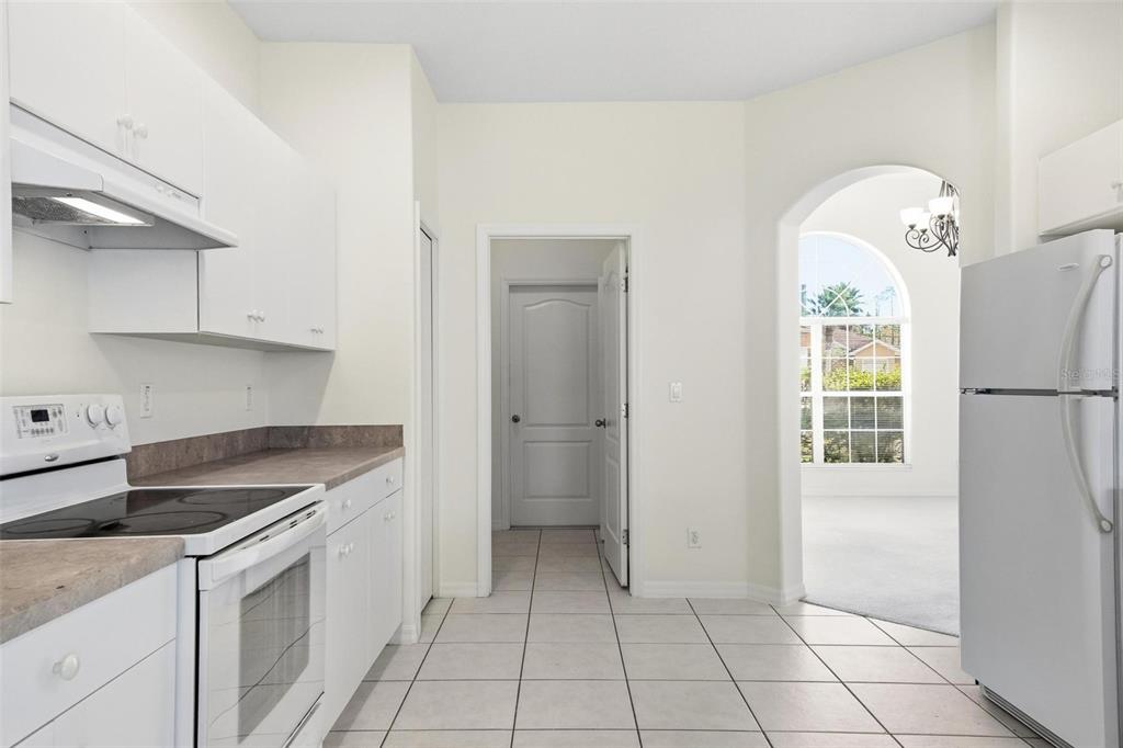 29 East Diamond Drive Palm Coast, FL 32164 - Photo 15 of 55 a kitchen with white cabinets and white appliances