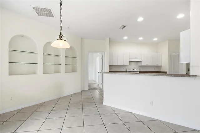 a kitchen with stainless steel appliances a refrigerator and a stove