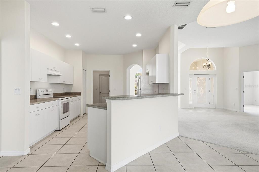 29 East Diamond Drive Palm Coast, FL 32164 - Photo 18 of 55 a large white kitchen with cabinets and white appliances