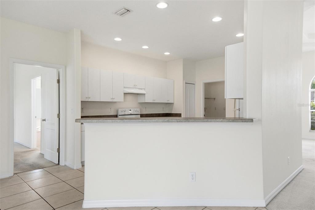29 East Diamond Drive Palm Coast, FL 32164 - Photo 19 of 55 a kitchen with stainless steel appliances a refrigerator and a stove