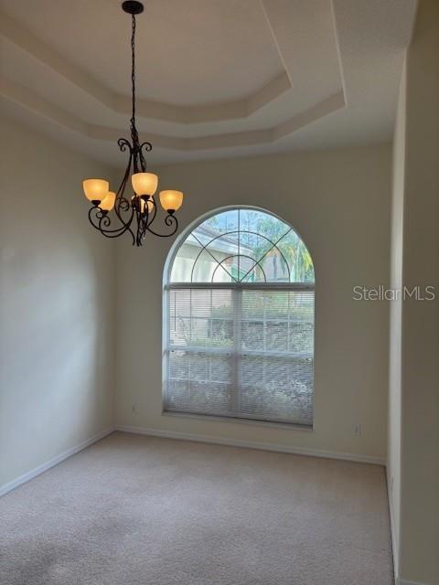 29 East Diamond Drive Palm Coast, FL 32164 - Photo 24 of 55 a view of a room with a chandelier fan and wooden floor