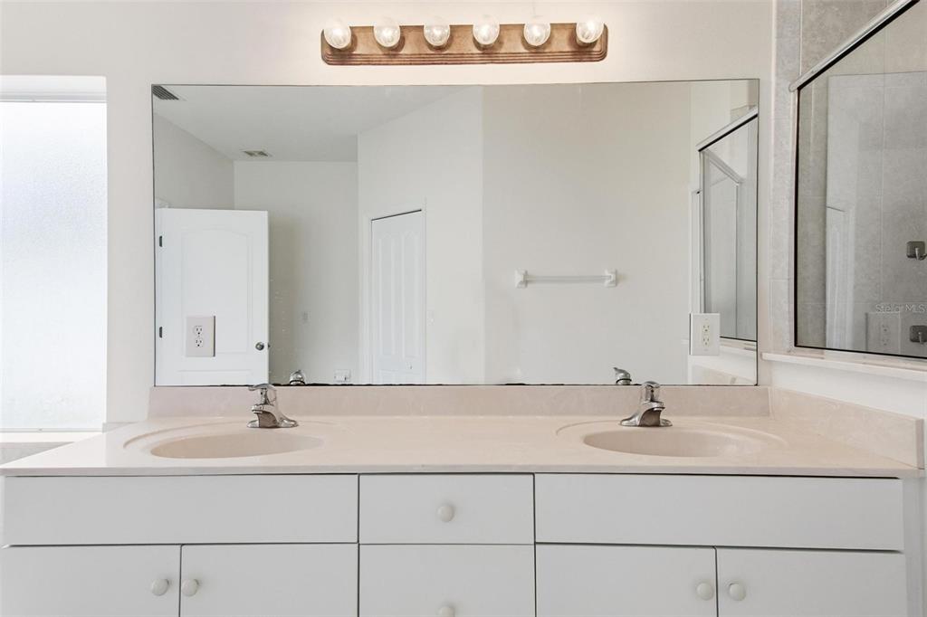 29 East Diamond Drive Palm Coast, FL 32164 - Photo 40 of 55 a bathroom with a sink and a mirror