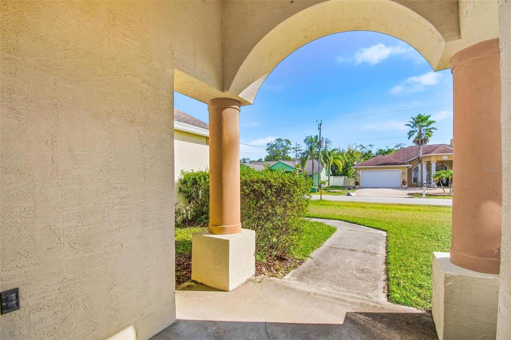 29 East Diamond Drive Palm Coast, FL 32164 - Photo 6 of 55 a view of a patio with a table and chairs potted plants