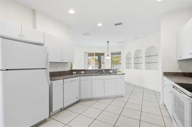 a kitchen with stainless steel appliances a sink and a refrigerator