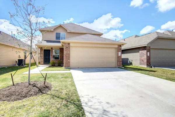 a view of a house with a backyard and a road